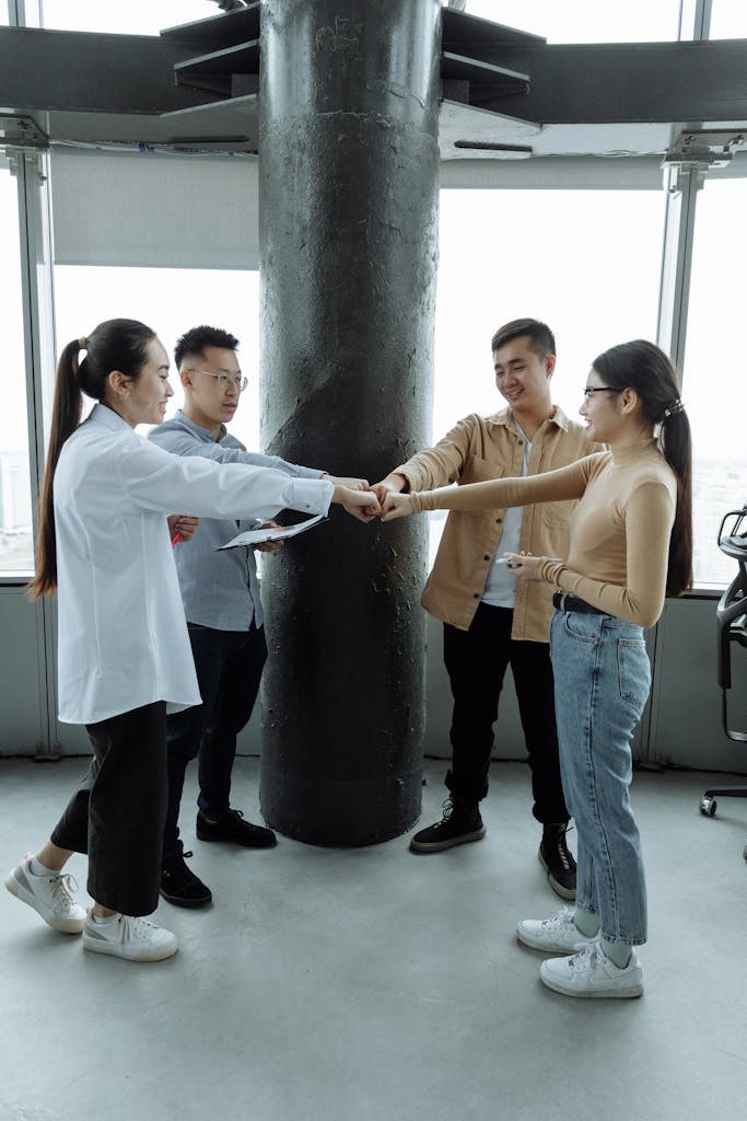 A group of four young professionals collaborating in a contemporary office setting.